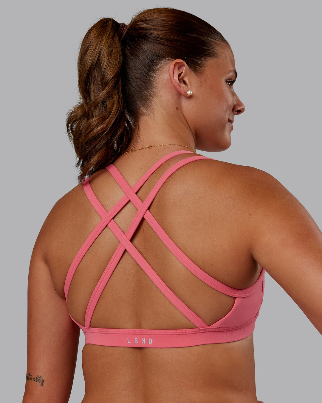 Woman wearing Velocity Sports Bra -- Pink Lemonade | Model:Phoebe | Size:S - view 1