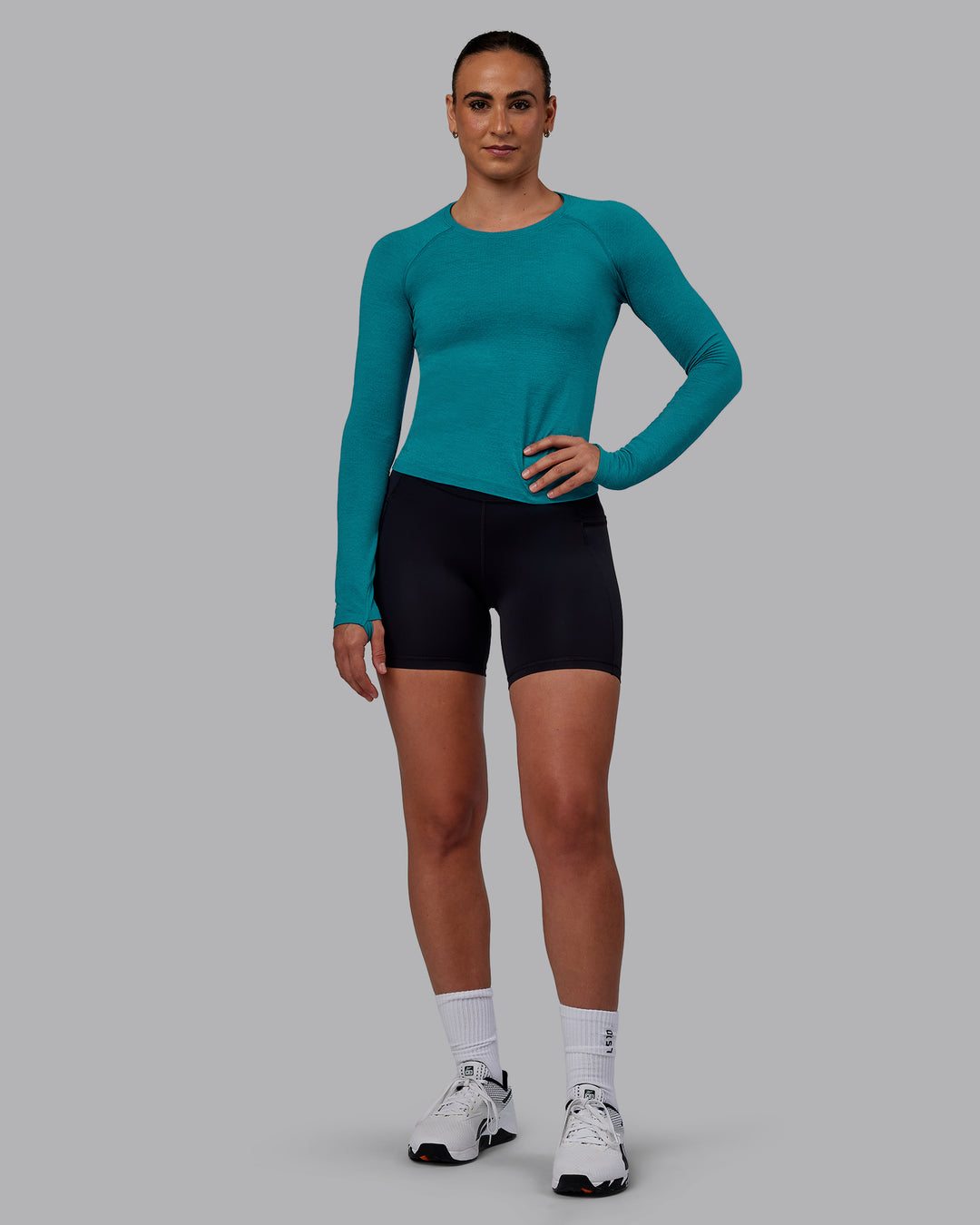 Woman wearing AeroFLX+ Seamless Long Sleeve Tee - Blue Bird Marl - view 1