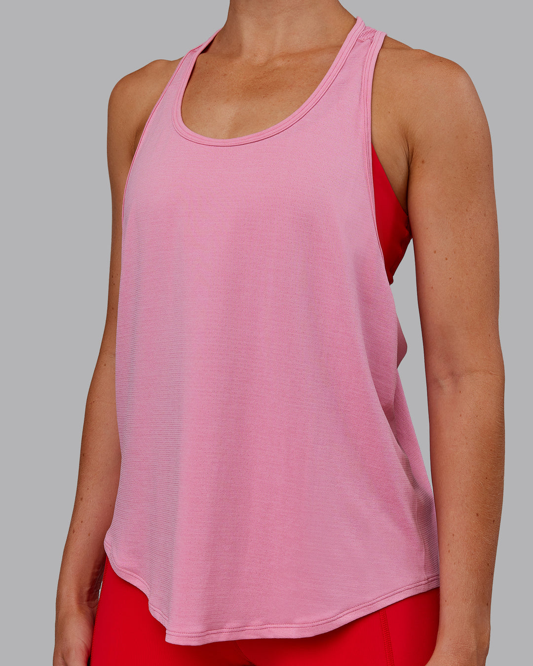 Woman wearing AeroFLX+ Drop Armhole Seamless Tank - Candy Pink | Model:Paris | Size:S - view 10