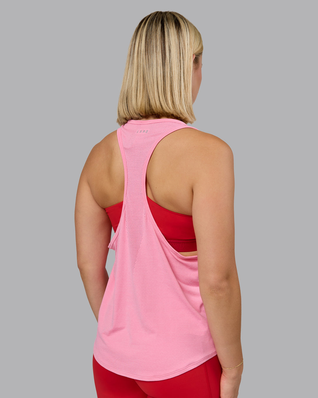 Woman wearing AeroFLX+ Drop Armhole Seamless Tank - Candy Pink | Model:Halle | Size:S - view 2