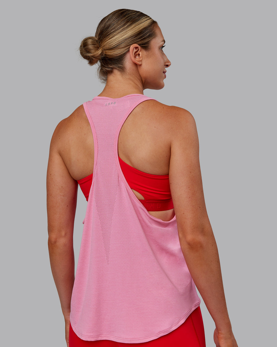 Woman wearing AeroFLX+ Drop Armhole Seamless Tank - Candy Pink | Model:Paris | Size:S - view 5