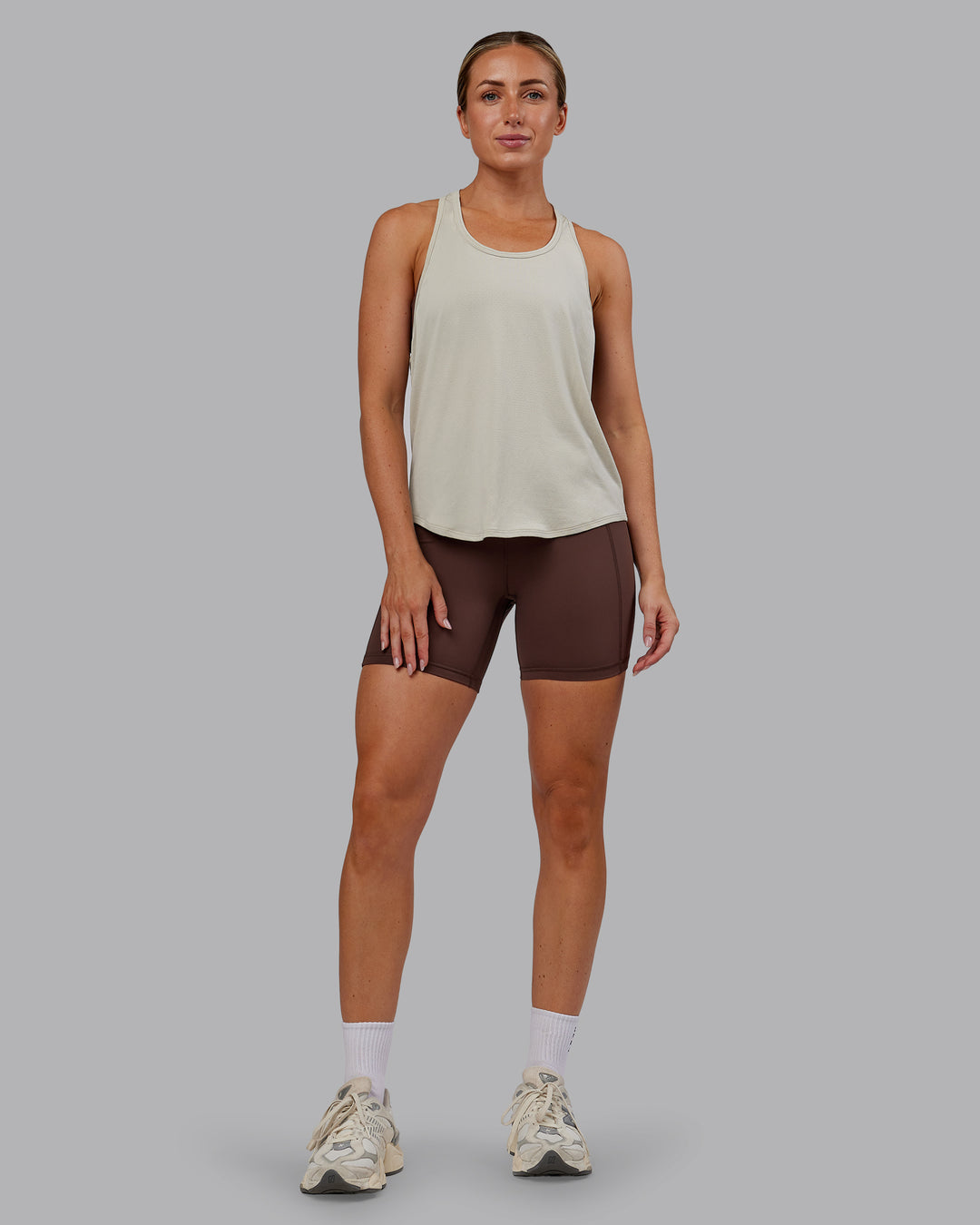 Woman wearing AeroFLX+ Drop Armhole Seamless Tank - Shale Beige | Model:Paris | Size:S - view 8