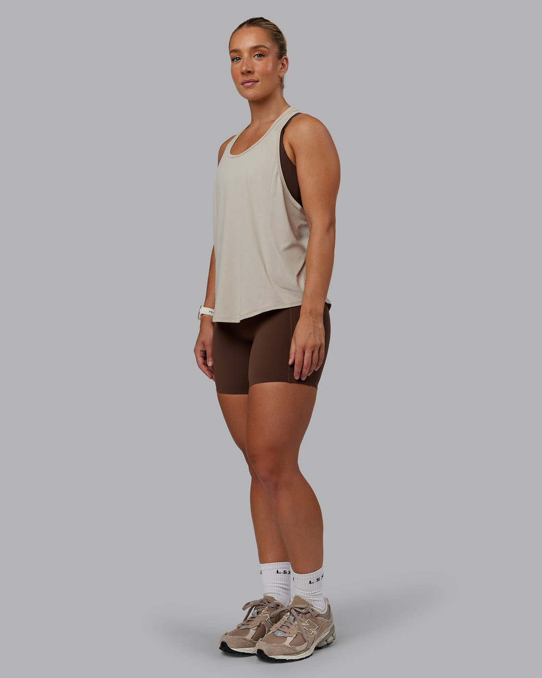 Woman wearing AeroFLX+ Drop Armhole Seamless Tank - Shale Beige | Model:Lyss | Size:S - view 4