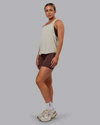 Woman wearing AeroFLX+ Drop Armhole Seamless Tank - Shale Beige | Model:Paris | Size:S | Thumbnail Index: 1