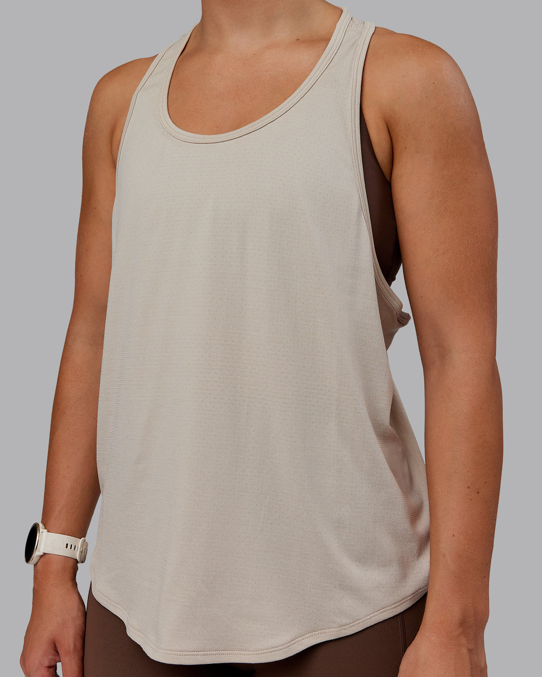 Woman wearing AeroFLX+ Drop Armhole Seamless Tank - Shale Beige | Model:Lyss | Size:S - view 3