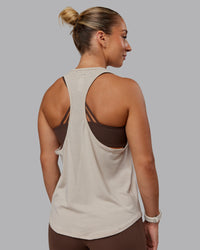 Woman wearing AeroFLX+ Drop Armhole Seamless Tank - Shale Beige | Model:Lyss | Size:S | Thumbnail Index: 0