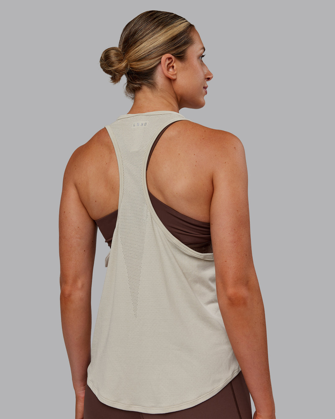 Woman wearing AeroFLX+ Drop Armhole Seamless Tank - Shale Beige | Model:Paris | Size:S - view 5