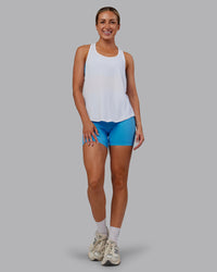 Woman wearing AeroFLX+ Drop Armhole Seamless Tank - White | Model:Paris | Size:S | Thumbnail Index: 1