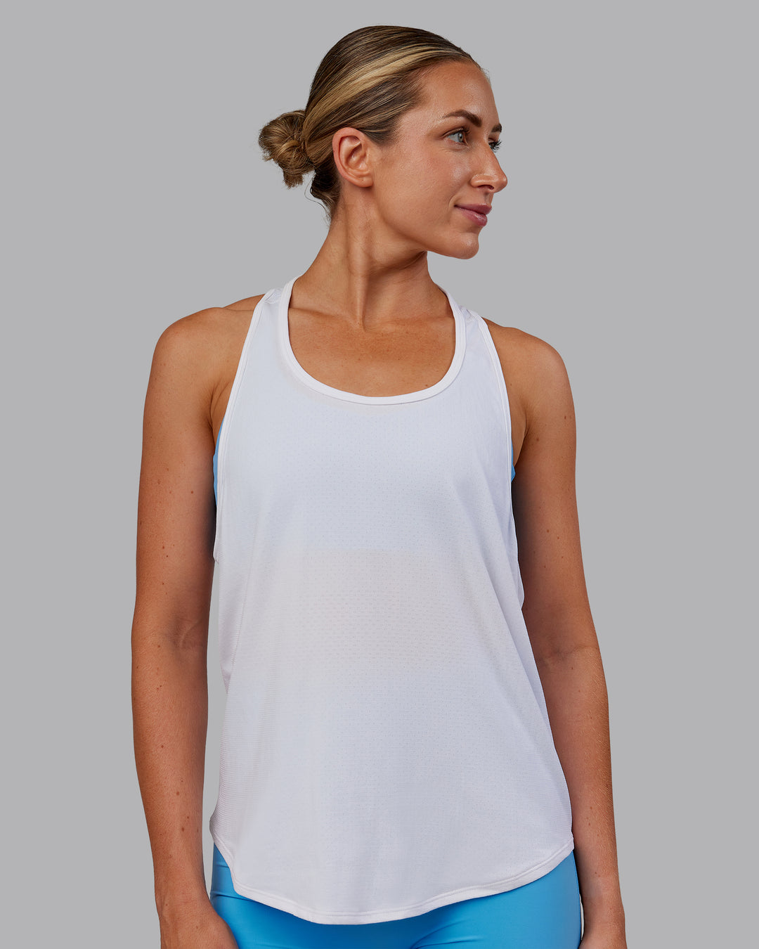 Woman wearing AeroFLX+ Drop Armhole Seamless Tank - White | Model:Paris | Size:S - view 5