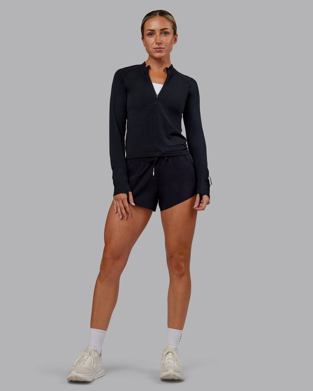 Woman wearing AeroFLX+ Long Sleeve Half Zip - Black Marl | Model:Paris | Size:S - view 5