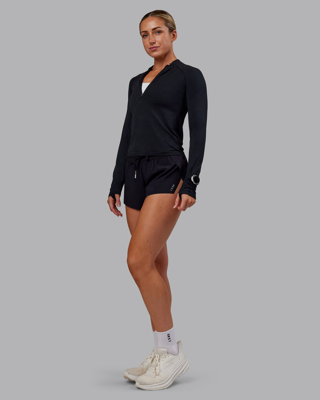 Woman wearing AeroFLX+ Long Sleeve Half Zip - Black Marl | Model:Paris | Size:S - view 2