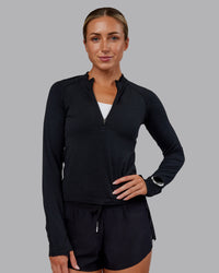 Woman wearing AeroFLX+ Long Sleeve Half Zip - Black Marl | Model:Paris | Size:S | Thumbnail Index: 0