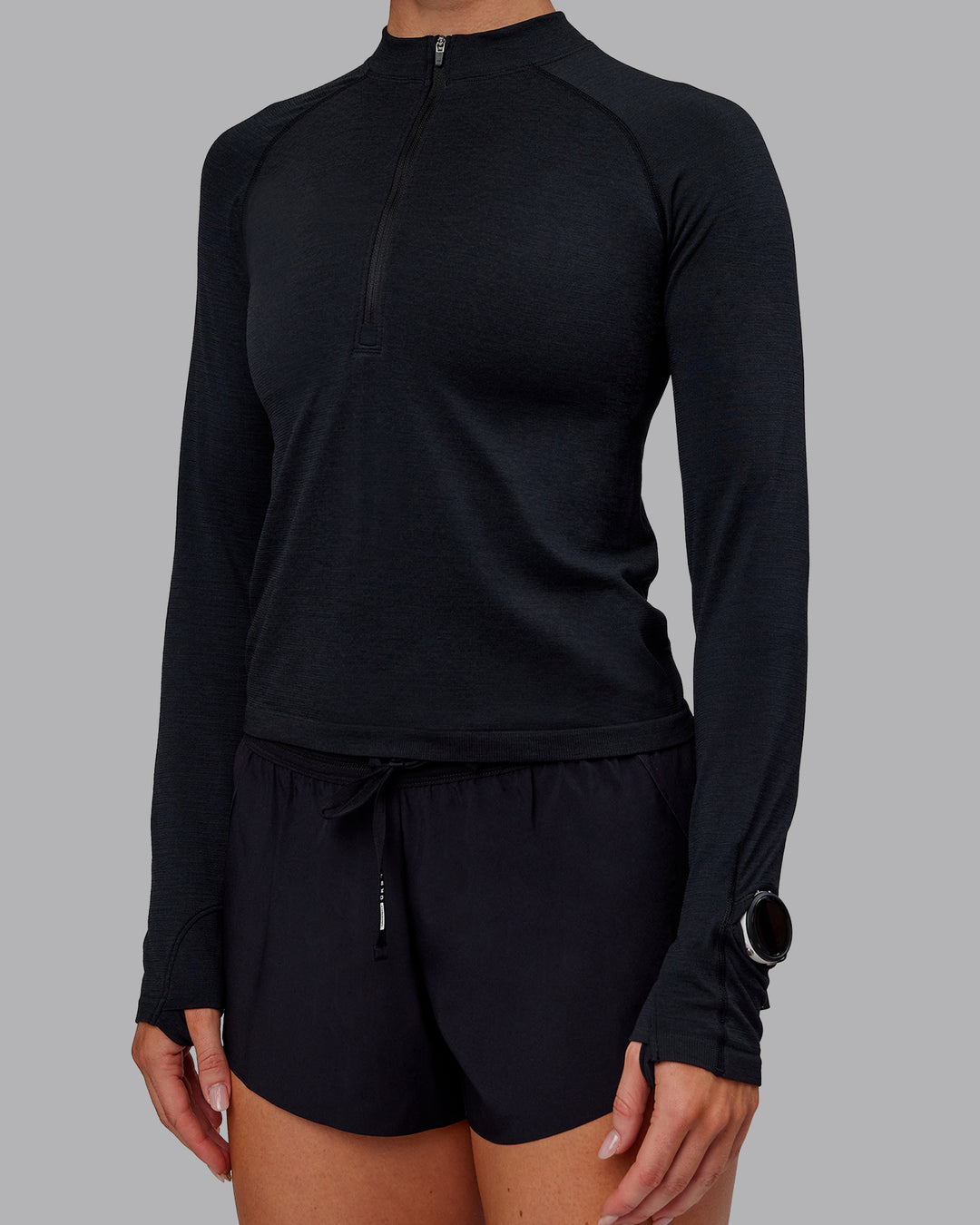 Woman wearing AeroFLX+ Long Sleeve Half Zip - Black Marl | Model:Paris | Size:S - view 6