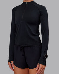 Woman wearing AeroFLX+ Long Sleeve Half Zip - Black Marl | Model:Paris | Size:S | Thumbnail Index: 5