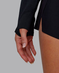 Woman wearing AeroFLX+ Long Sleeve Half Zip - Black Marl | Model:Paris | Size:S | Thumbnail Index: 6