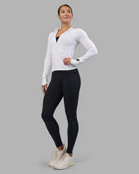 Woman wearing AeroFLX+ Long Sleeve Half Zip - White/White | Model:Hannah | Size:S | Thumbnail Index: 1