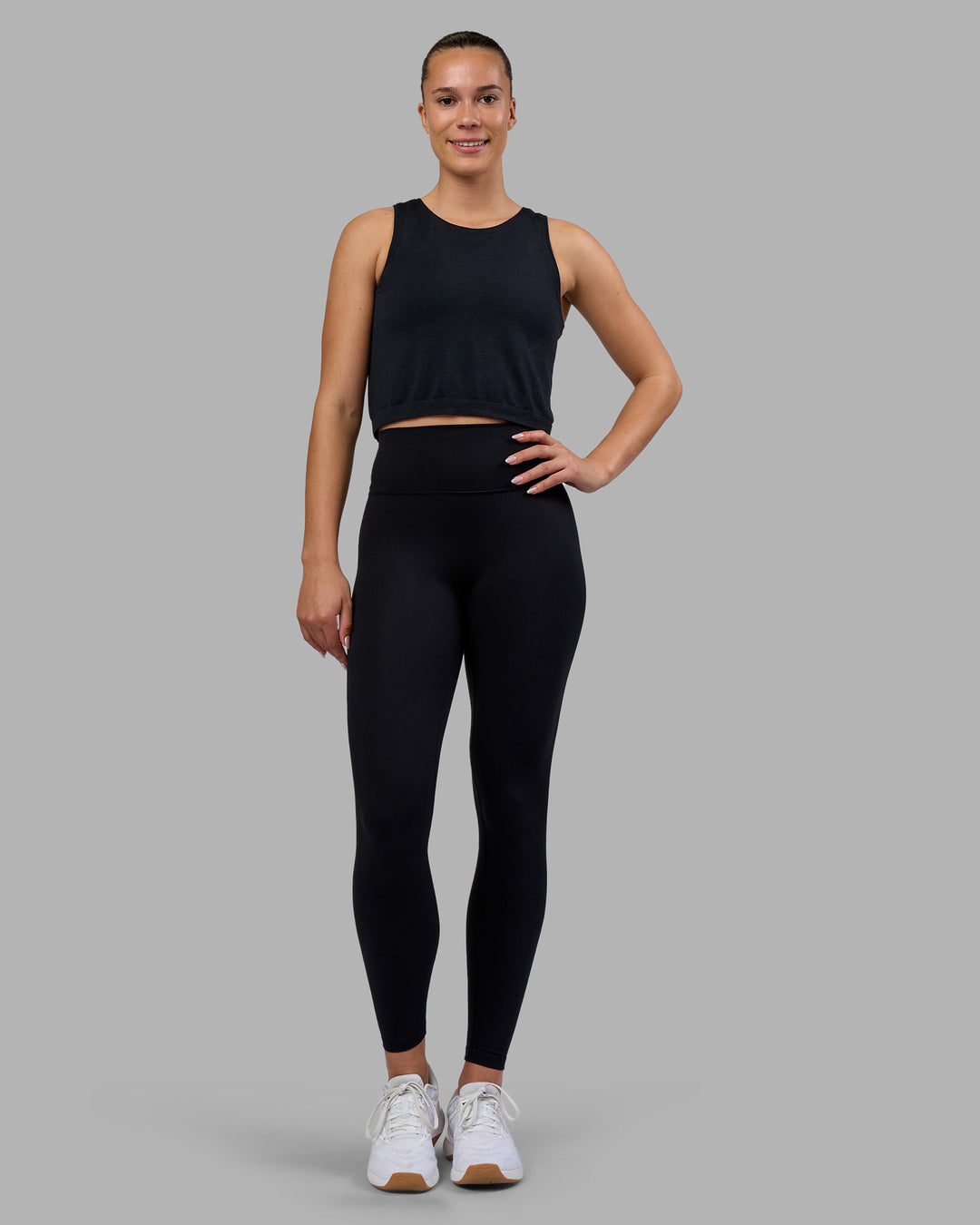 Woman wearing AeroFLX+ Seamless Skimmer Tank - Black Marl | Model:Charlize | Size:S - view 3