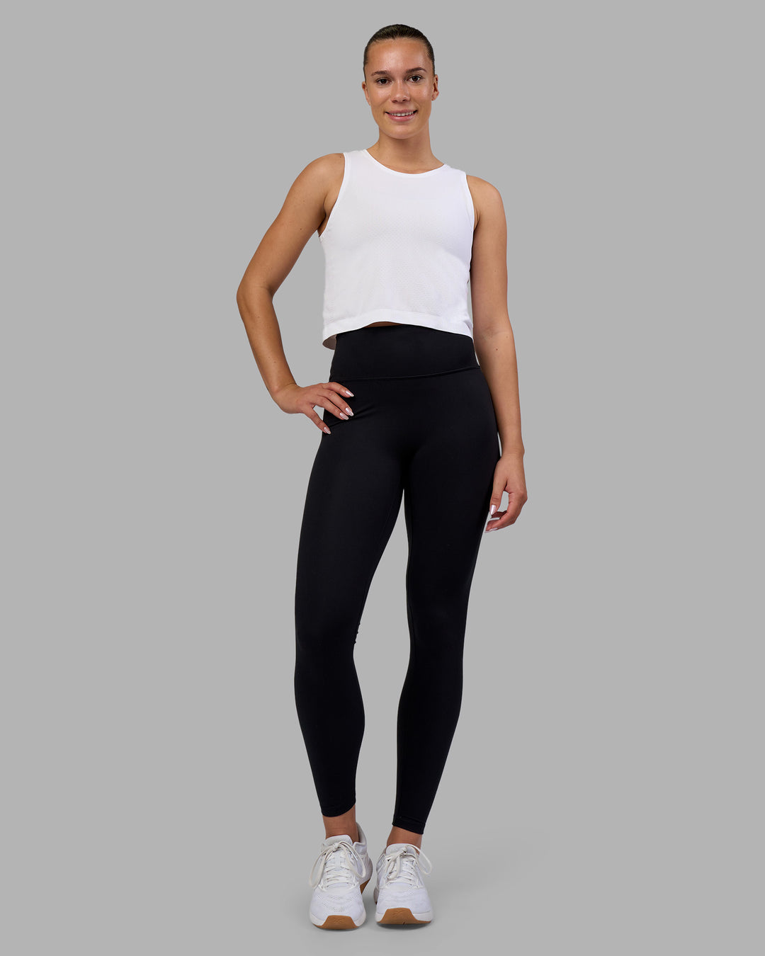Woman wearing AeroFLX+ Seamless Skimmer Tank - White/White | Model:Charlize | Size:S - view 2