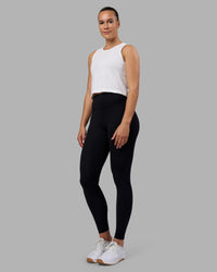 Woman wearing AeroFLX+ Seamless Skimmer Tank - White/White | Model:Charlize | Size:S | Thumbnail Index: 3