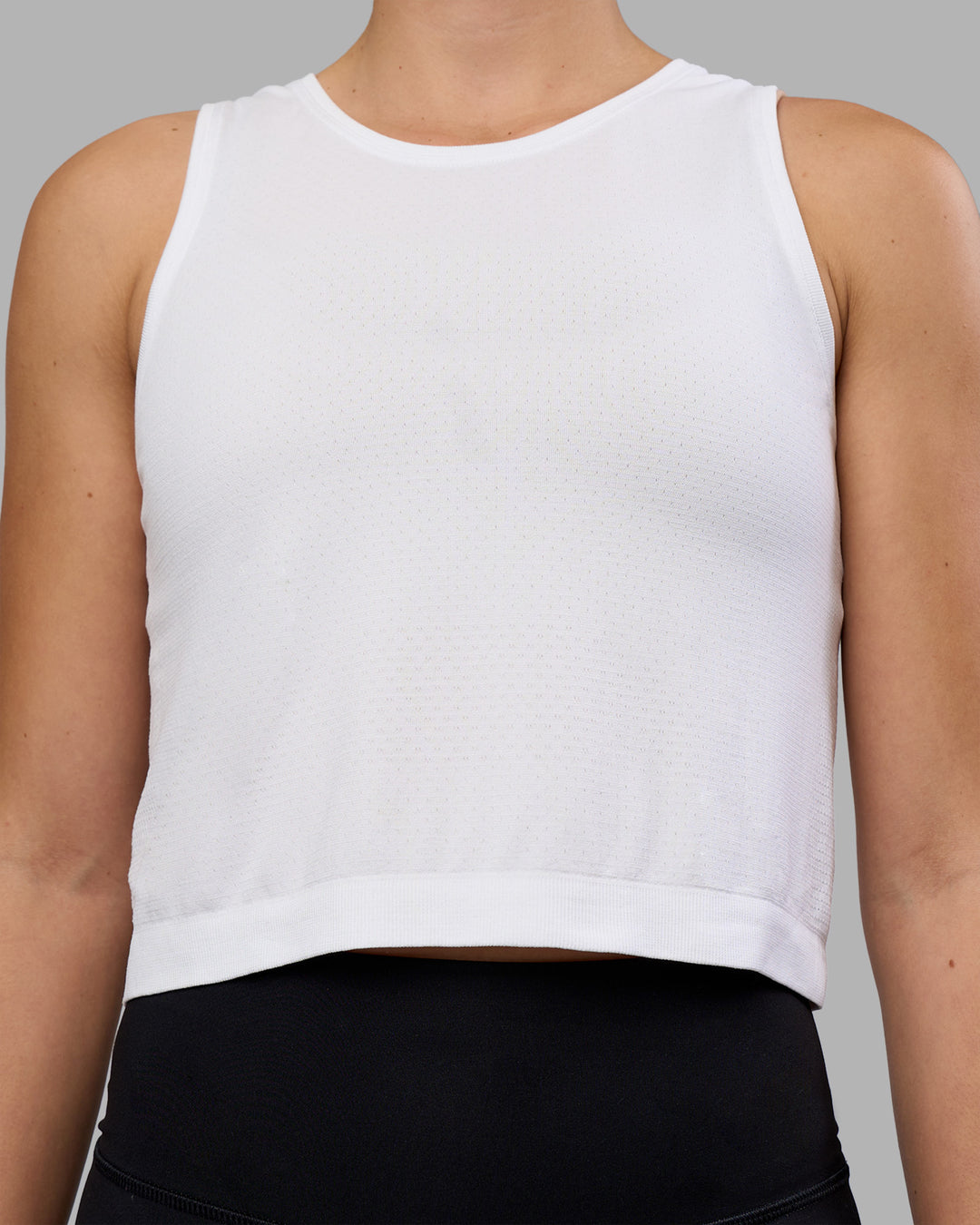 Woman wearing AeroFLX+ Seamless Skimmer Tank - White/White | Model:Charlize | Size:S - view 5
