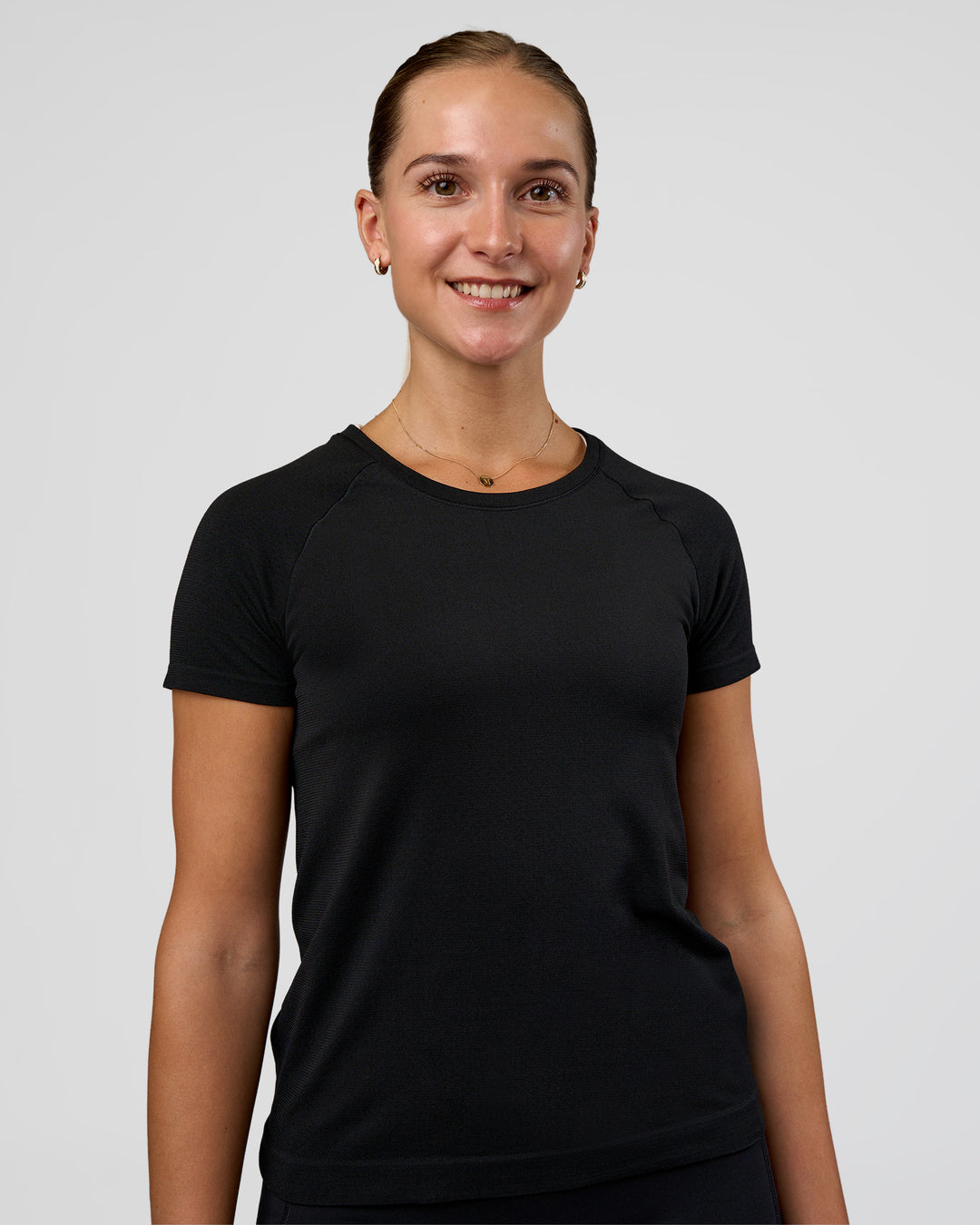 Woman wearing AeroFLX+ Seamless Tee - Black/Black | Model:Myrte | Size:S - view 1