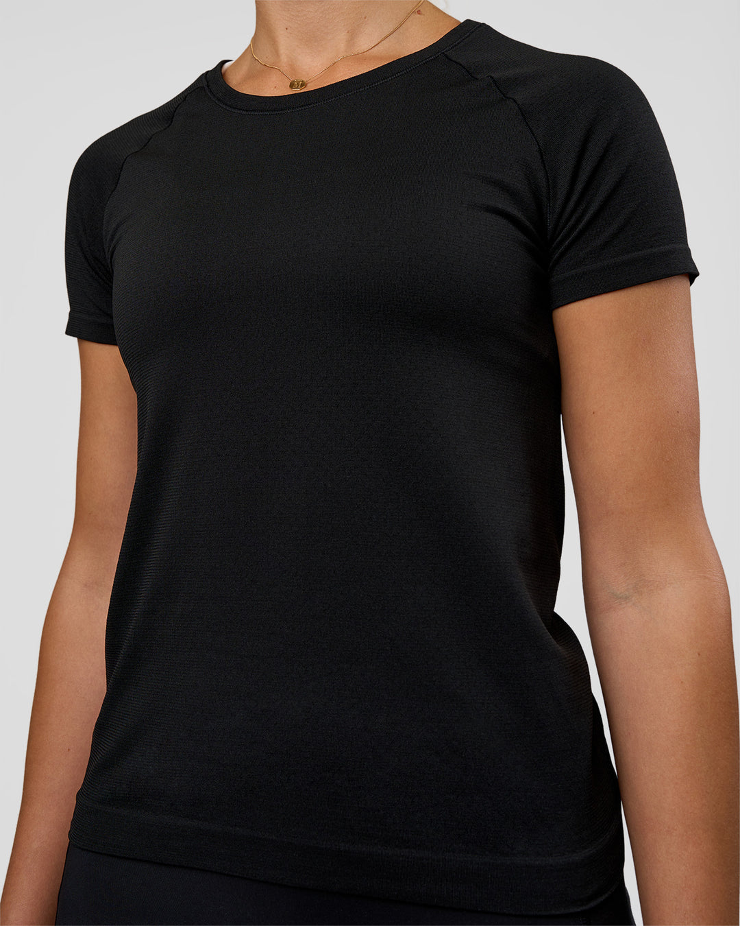 Woman wearing AeroFLX+ Seamless Tee - Black/Black | Model:Myrte | Size:S - view 5