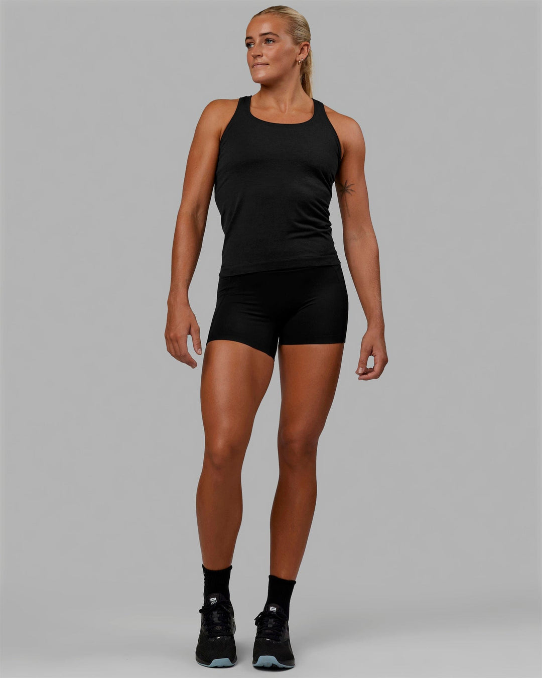 Woman wearing AeroFLX+ Seamless Tank - Black Marl - view 8