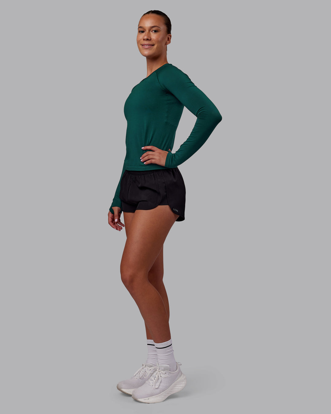 Woman wearing AeroFLX+ Seamless Long Sleeve Tee - Dark Moss/Dark Moss | Model:Charlize | Size:S - view 5