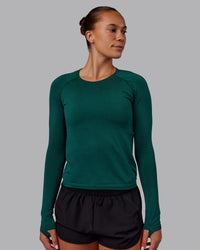 Woman wearing AeroFLX+ Seamless Long Sleeve Tee - Dark Moss/Dark Moss | Model:Charlize | Size:S | Thumbnail Index: 1