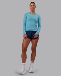 Woman wearing AeroFLX+ Seamless Long Sleeve Tee - Retro Blue/Retro Blue | Model:Charlize | Size:S | Thumbnail Index: 0