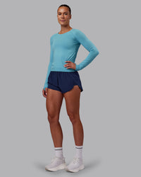 Woman wearing AeroFLX+ Seamless Long Sleeve Tee - Retro Blue/Retro Blue | Model:Charlize | Size:S | Thumbnail Index: 4