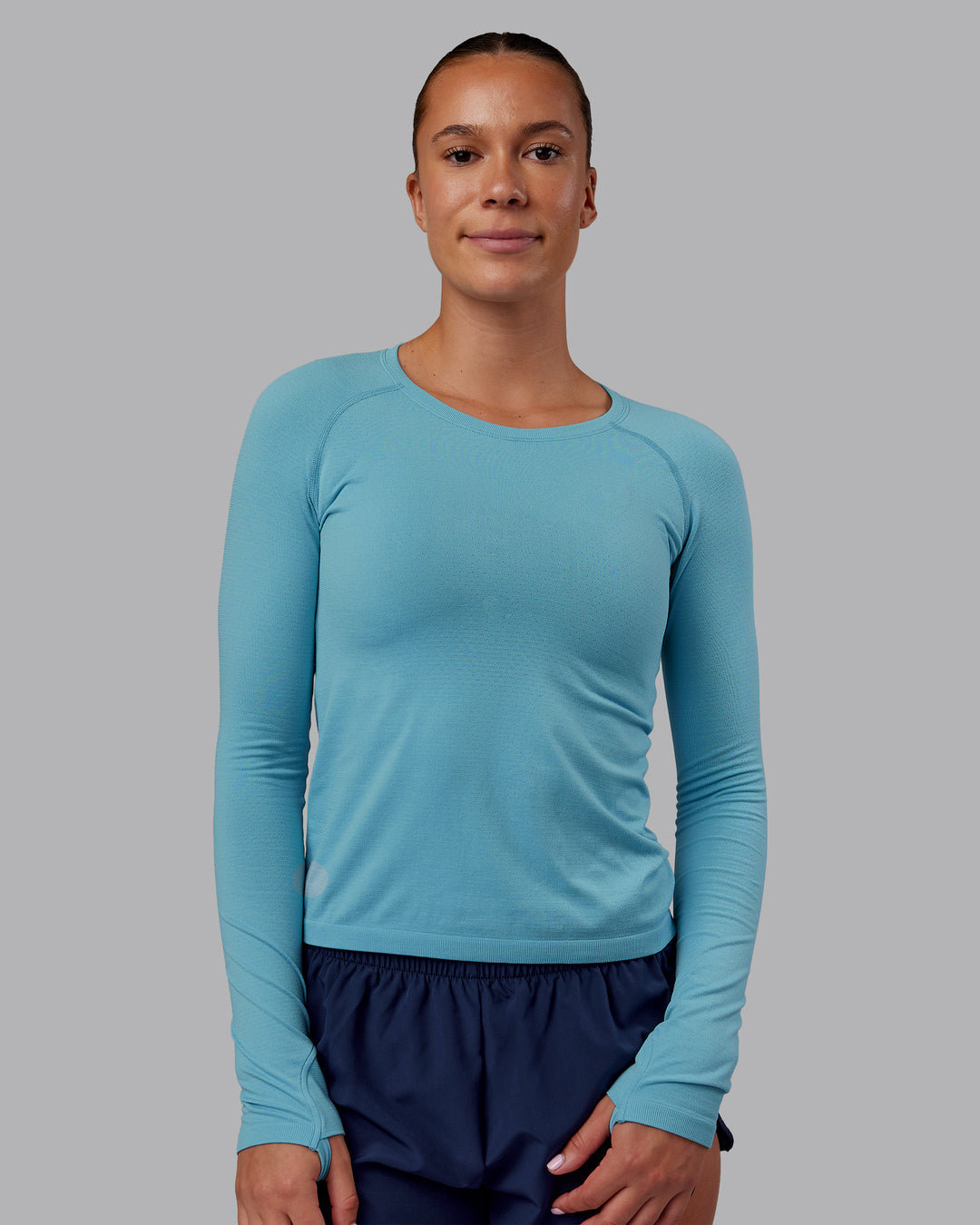 Woman wearing AeroFLX+ Seamless Long Sleeve Tee - Retro Blue/Retro Blue | Model:Charlize | Size:S - view 2