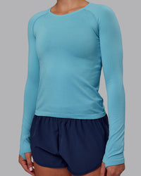 Woman wearing AeroFLX+ Seamless Long Sleeve Tee - Retro Blue/Retro Blue | Model:Charlize | Size:S | Thumbnail Index: 3