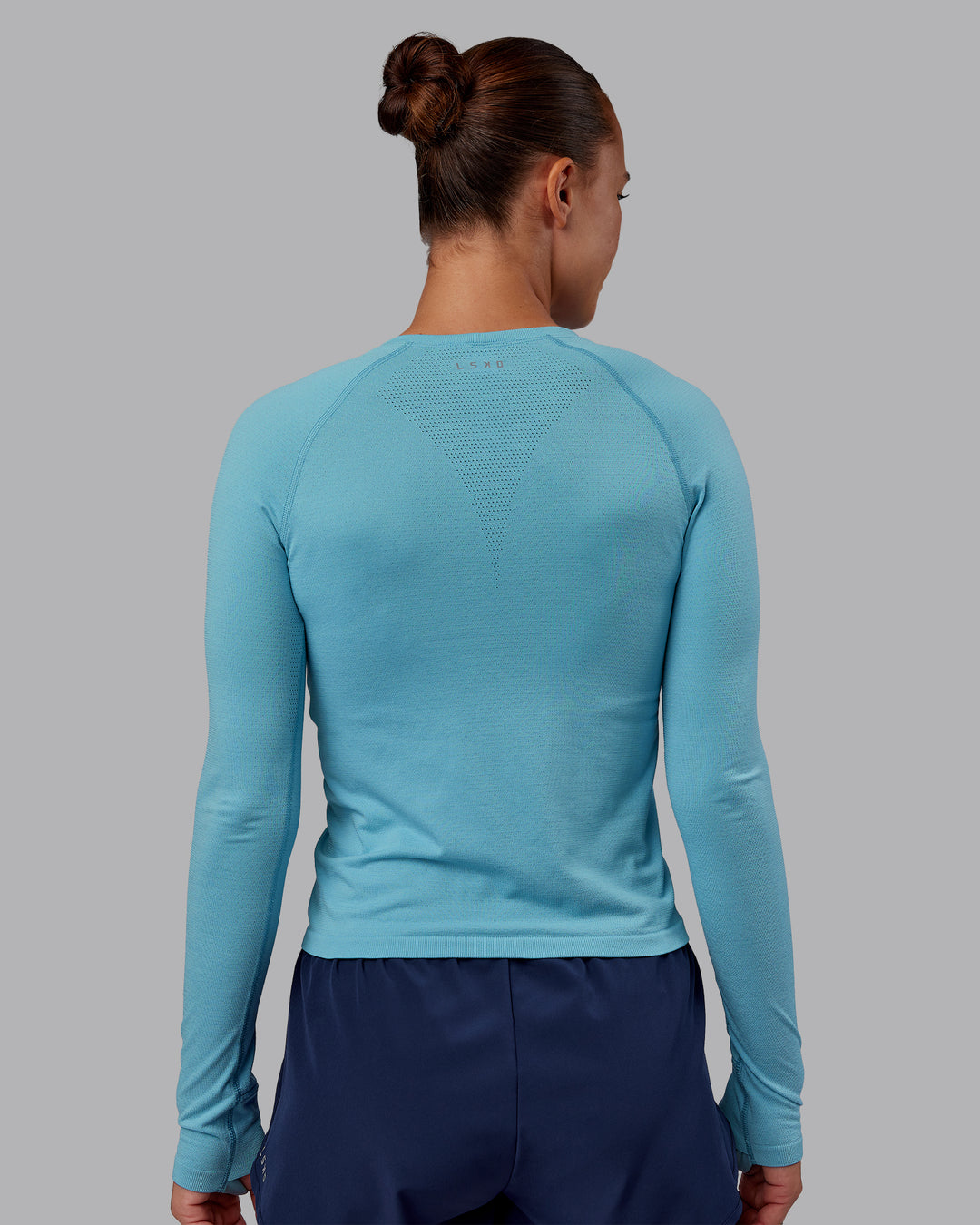 Woman wearing AeroFLX+ Seamless Long Sleeve Tee - Retro Blue/Retro Blue | Model:Charlize | Size:S - view 3