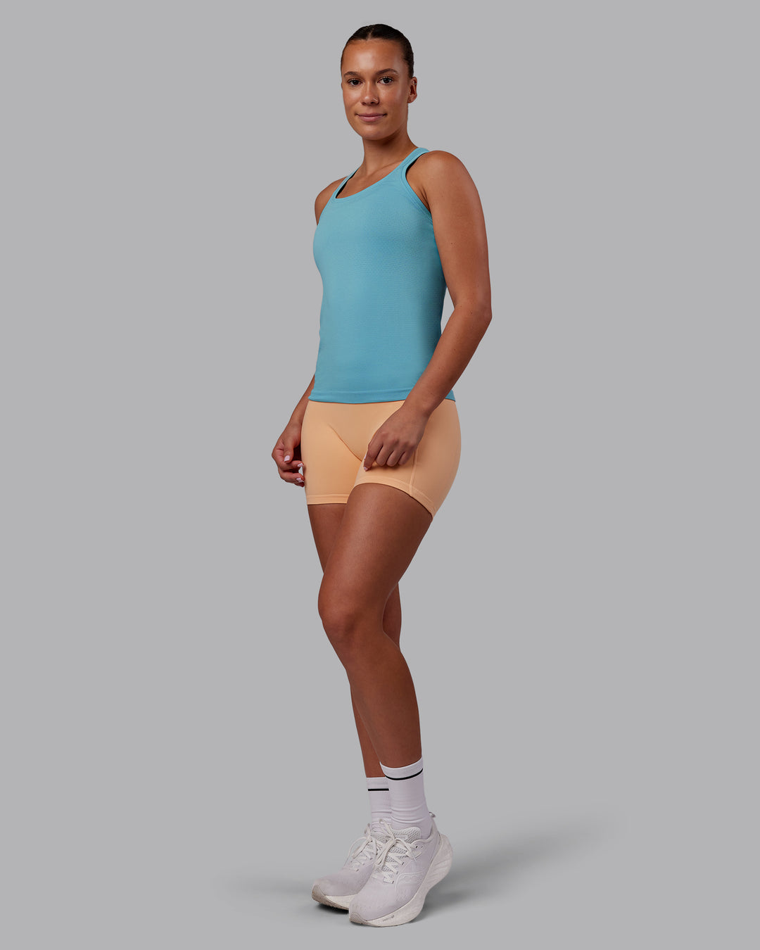 Woman wearing AeroFLX+ Seamless Tank - Retro Blue/Retro Blue | Model:Charlize | Size:S - view 4