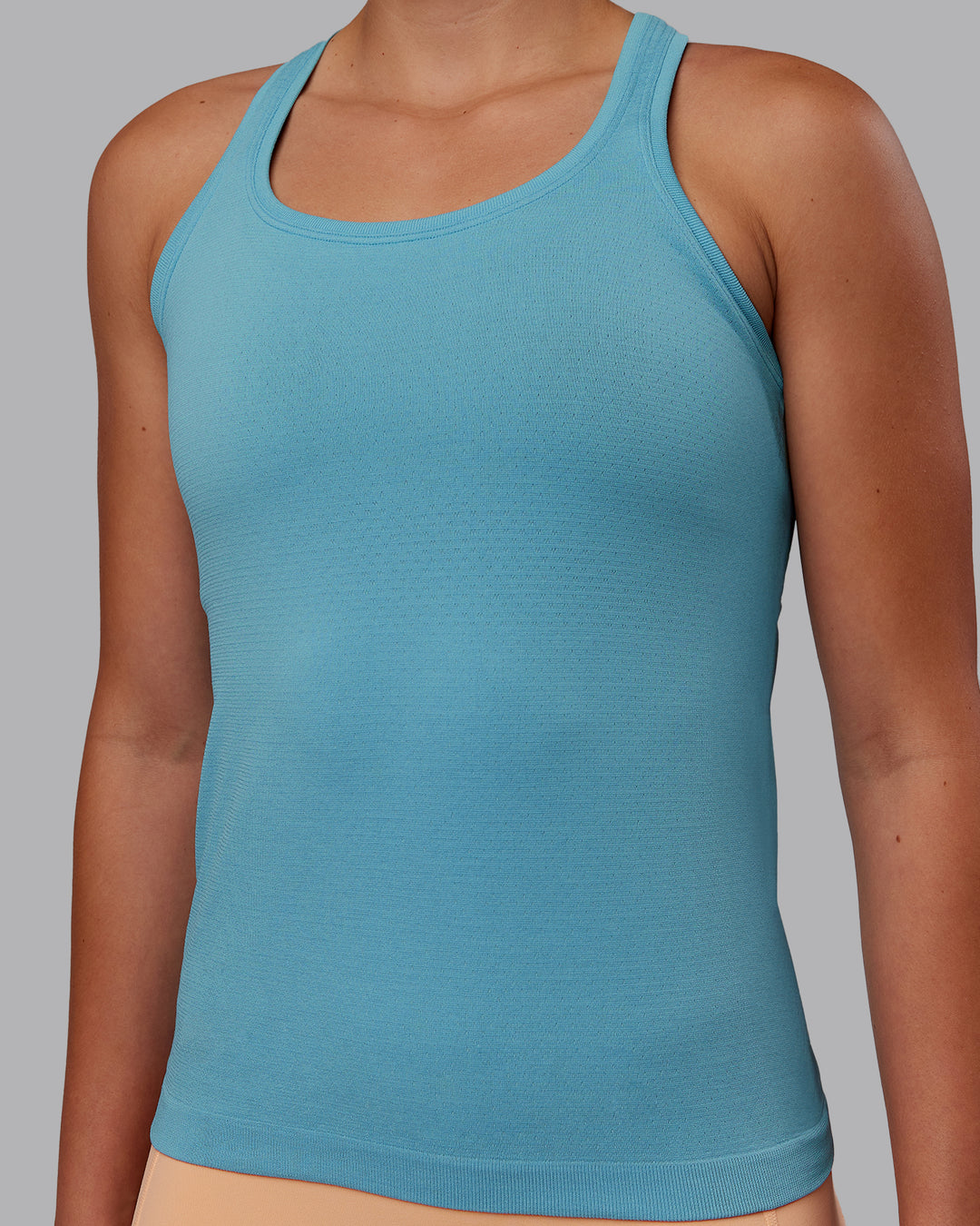 Woman wearing AeroFLX+ Seamless Tank - Retro Blue/Retro Blue | Model:Charlize | Size:S - view 5