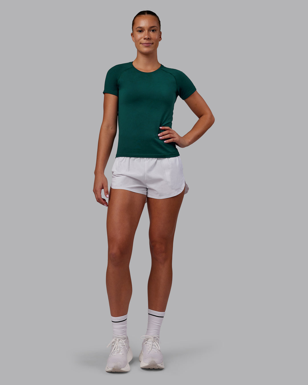 Woman wearing AeroFLX+ Seamless Tee - Dark Moss Marl | Model:Charlize | Size:S - view 4