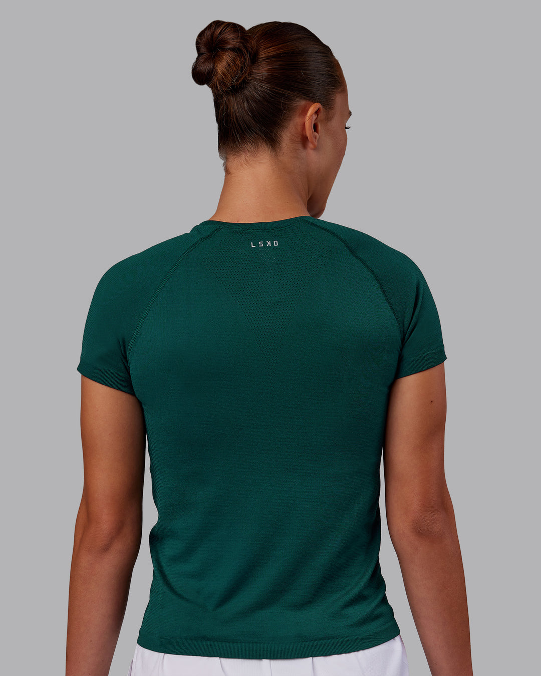 Woman wearing AeroFLX+ Seamless Tee - Dark Moss Marl | Model:Charlize | Size:S - view 3