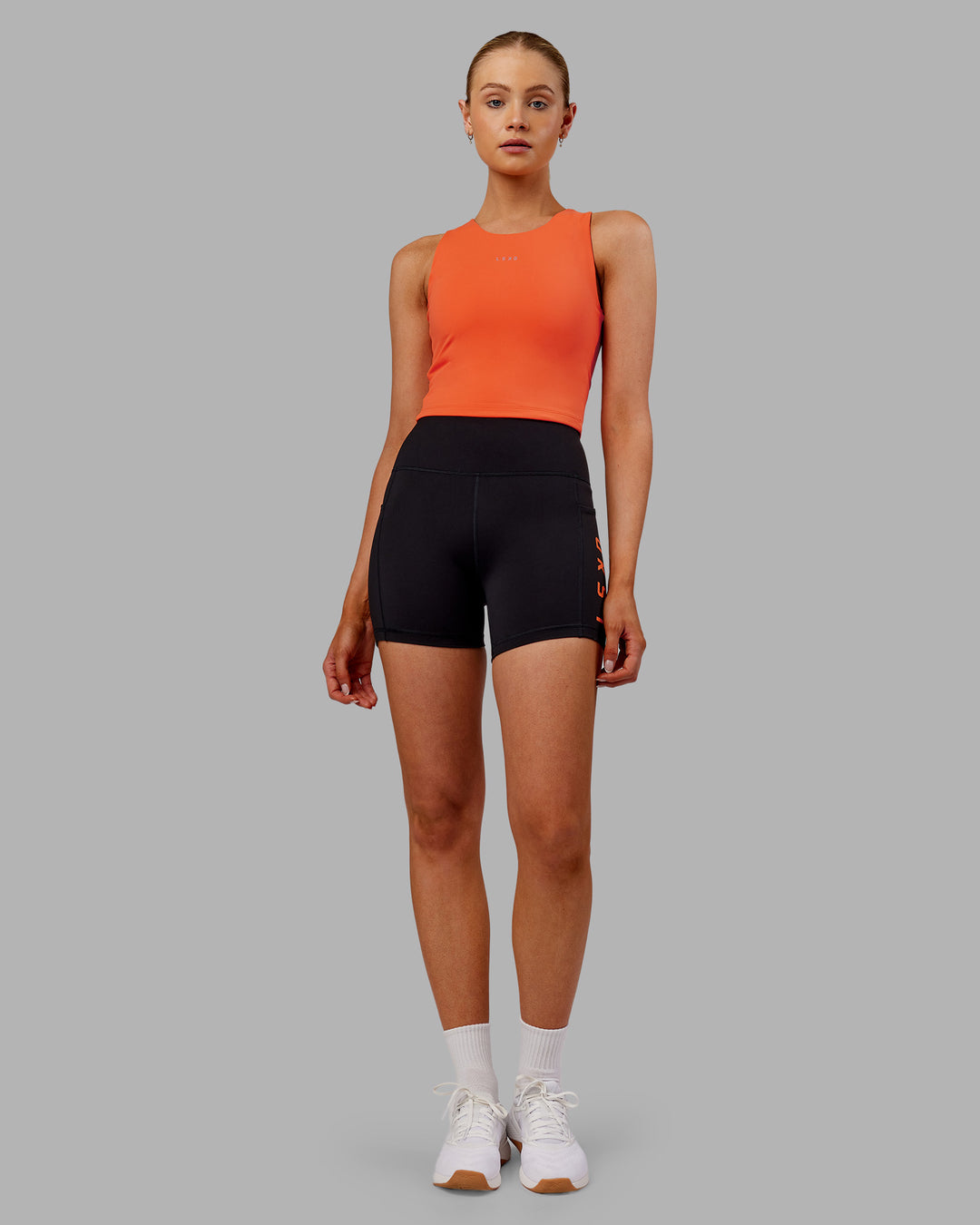 Woman wearing Base Tank - Ultra Orange | Model:Ella | Size:S - view 5