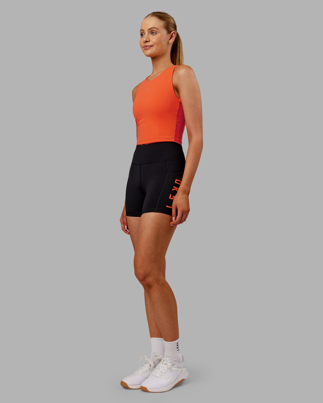 Woman wearing Base Tank - Ultra Orange | Model:Ella | Size:S - view 3