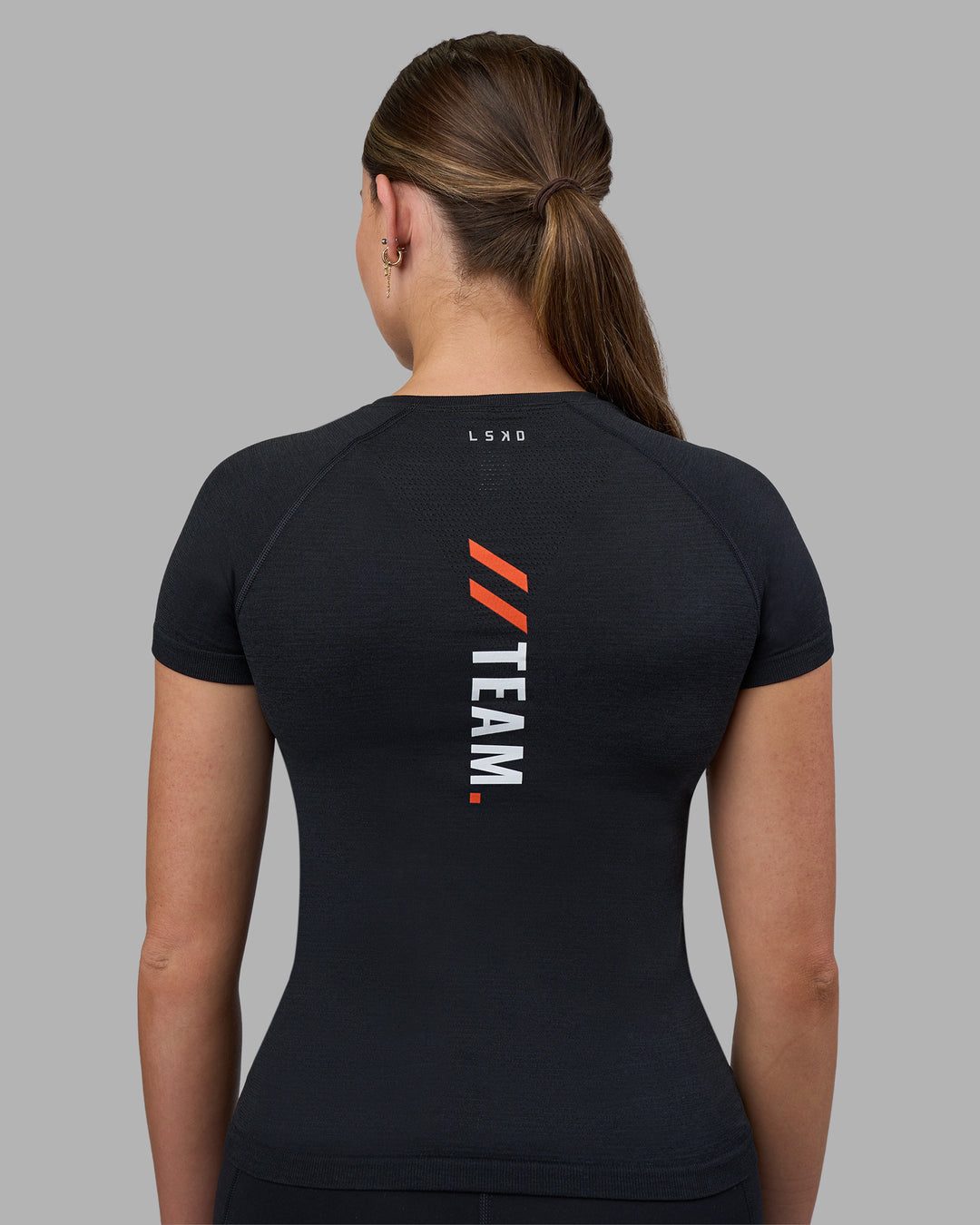 Woman wearing Fitstop AeroFLX+ Seamless Tee - Black | Model:Jade | Size:S - view 3