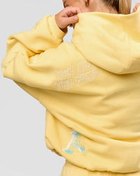 Woman wearing Zola Oversized Hoodie - Lemon | Model:Issy | Size:S | Thumbnail Index: 17