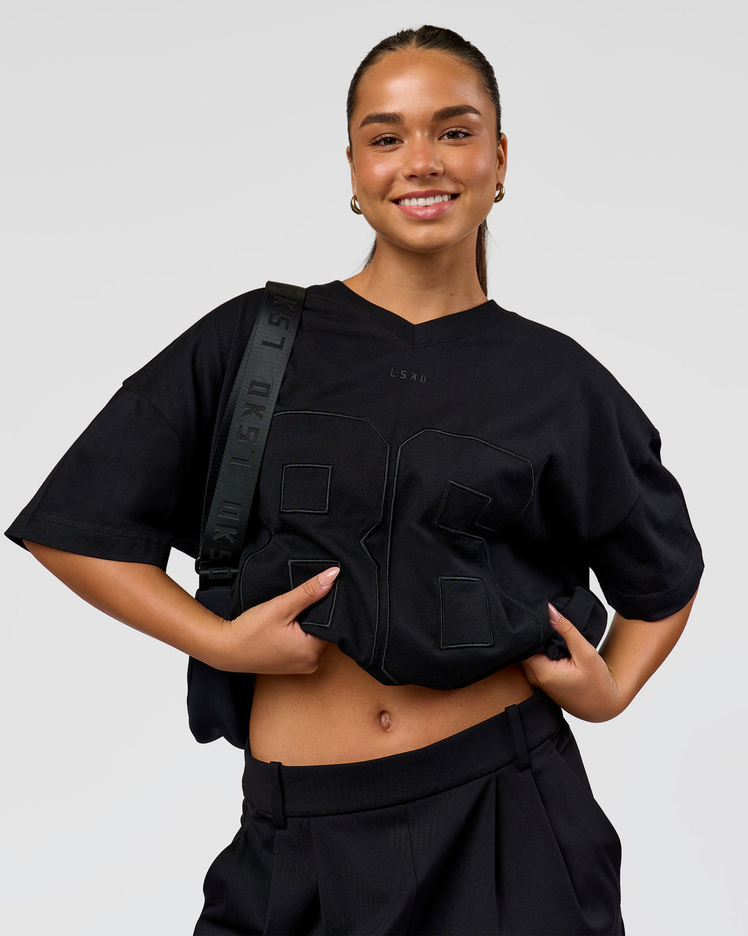 Woman wearing 86 V-Neck Oversized Tee - Black-Black | Model:Sophia | Size:S  - view 9