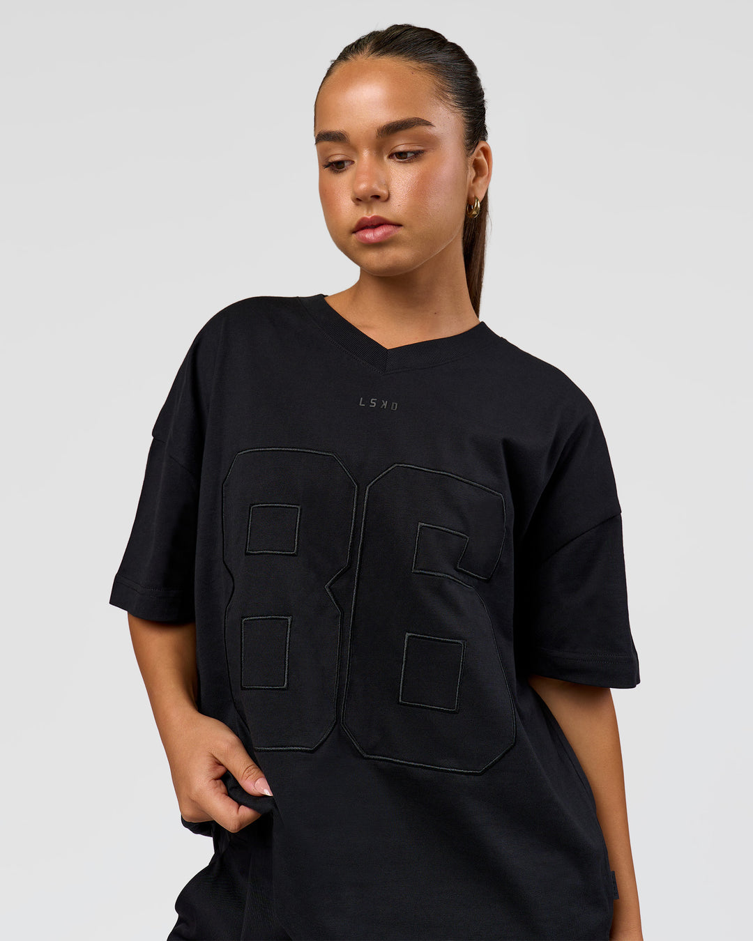 Woman wearing 86 V-Neck Oversized Tee - Black-Black | Model:Sophia | Size:S  - view 15