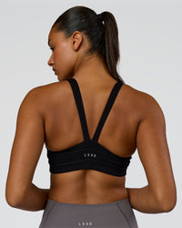 Woman wearing Inertia Sports Bra - Black | Model:Rosie | Size:S | Thumbnail Index: 1