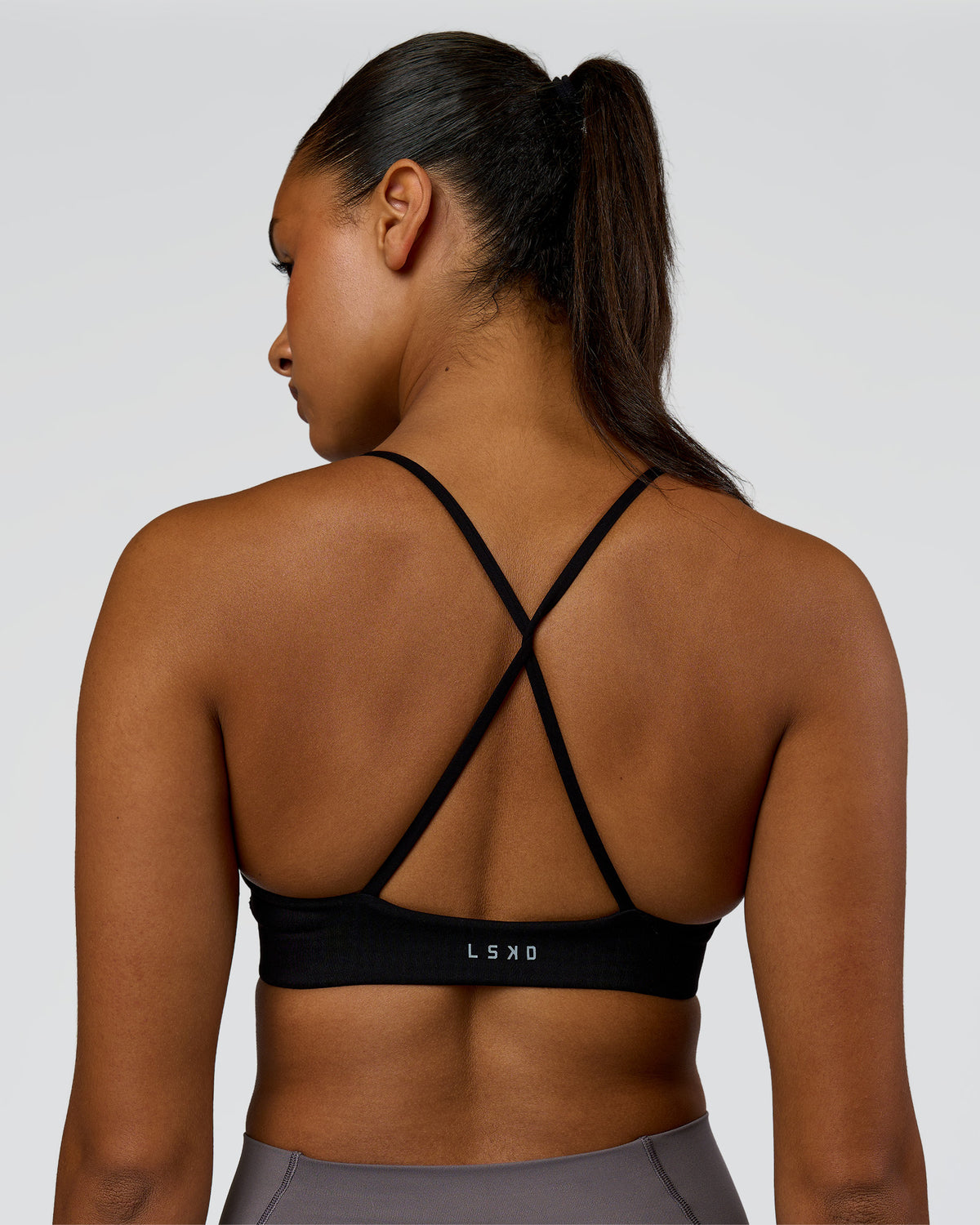 Woman wearing Infinite Contour Sports Bra - Black| Model:Rosie | Size:S