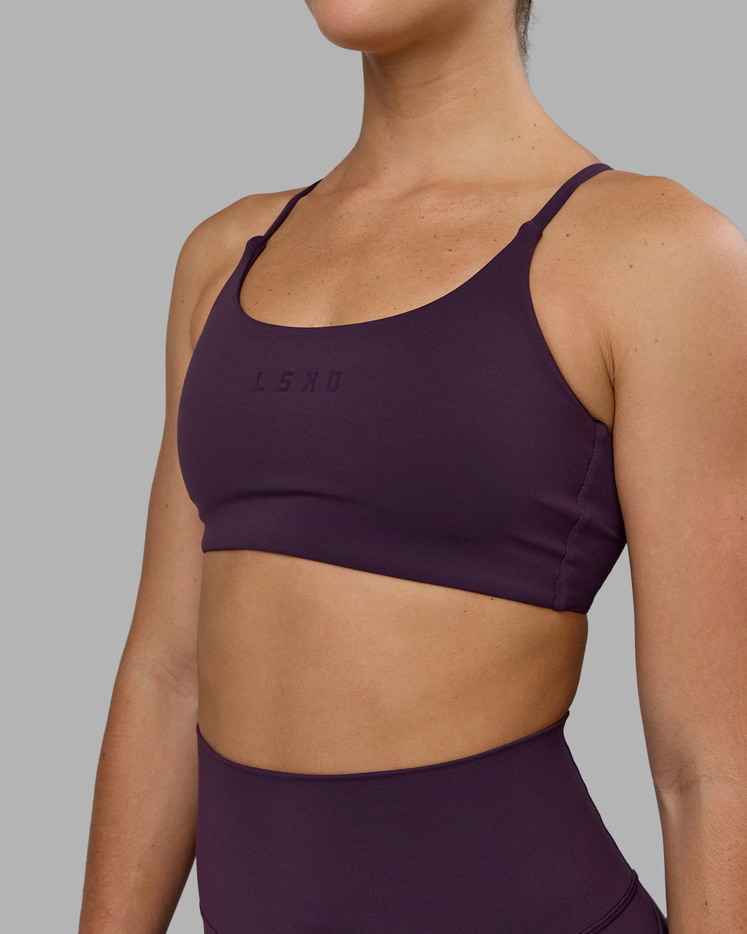 Woman wearing Twist Sports Bra - Midnight Plum - view 6