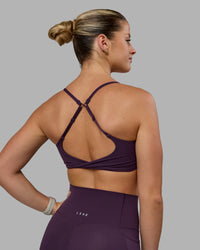 Woman wearing Twist Sports Bra - Midnight Plum | Thumbnail Index: 1