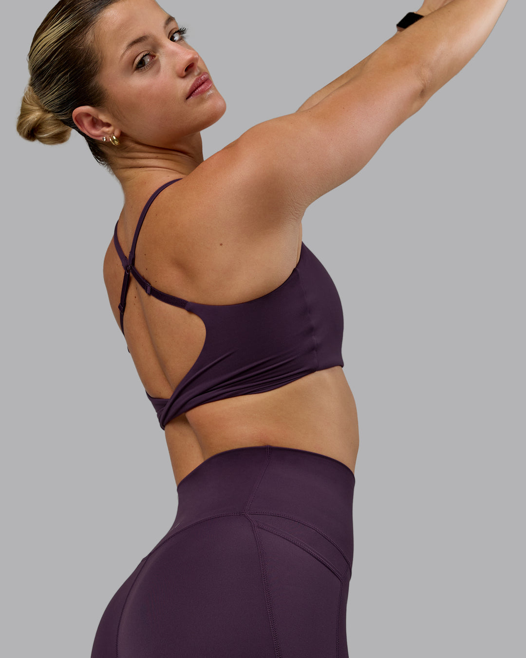 Woman wearing Twist Sports Bra - Midnight Plum - view 5