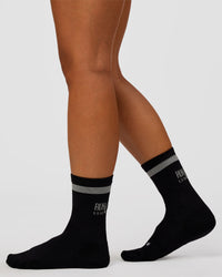 Woman wearing Run Club Fast Performance Socks 2.0 - Black-Reflective | Thumbnail Index: 3